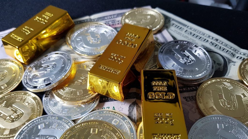 Gold bars, silver bullion-style coins, and U.S. currency arranged together to represent a Directed IRA, helping investors understand are gold IRAs a good idea, compare fold IRA companies, learn what is IRA silver, and determine what is IRA eligibility silver for precious metals retirement investing.