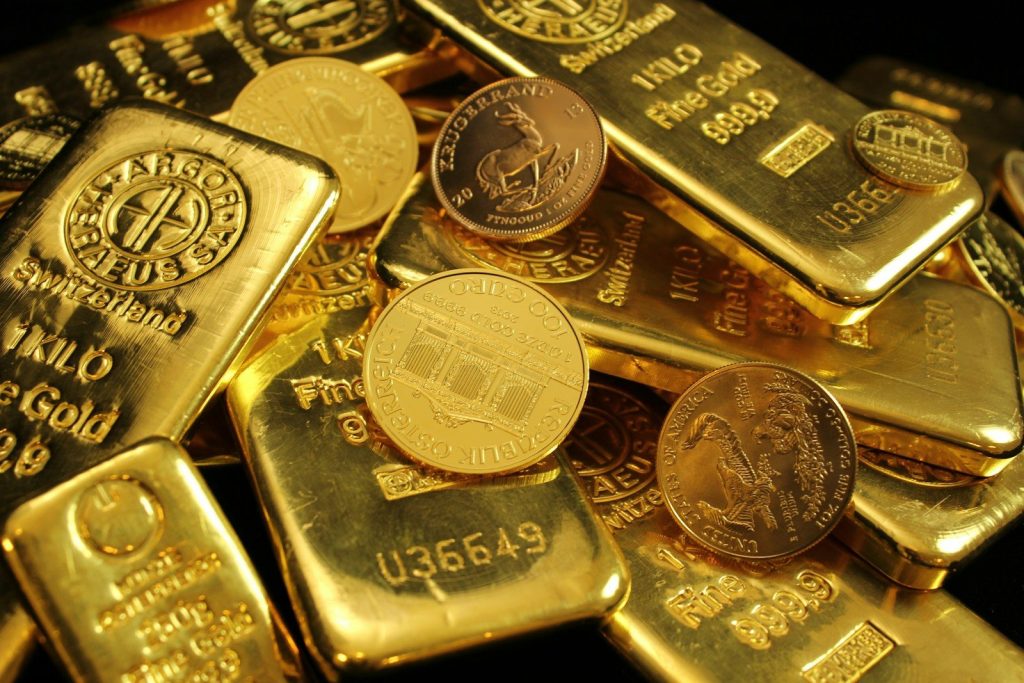 A pile of physical gold IRA assets from top gold IRA companies showing a gold IRA rollover option for investors changing IRA investments to gold and wondering can you own gold in an IRA.